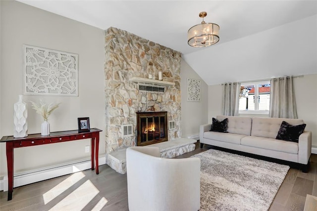 living room with a fireplace, lofted ceiling, an inviting chandelier, a baseboard heating unit, and wood finished floors