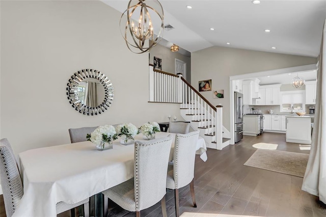 dining room with stairs, a chandelier, vaulted ceiling, and dark wood-style flooring