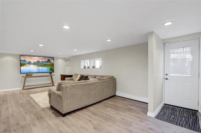 living room with light wood-style flooring, baseboards, and recessed lighting