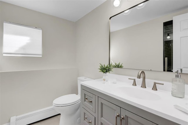 bathroom featuring toilet, a baseboard radiator, and vanity