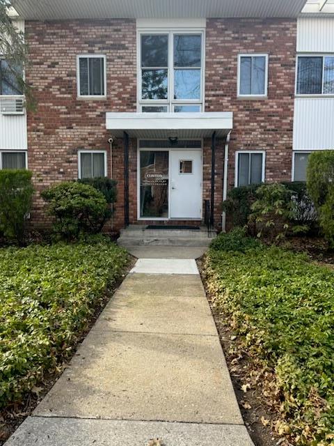 entrance to property featuring brick siding