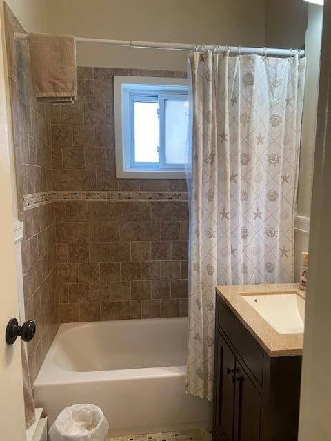 bathroom with shower / tub combo with curtain and vanity