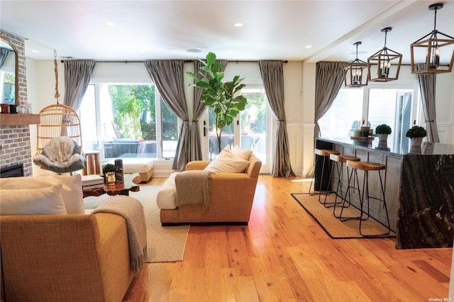 sitting room featuring recessed lighting, a healthy amount of sunlight, and light wood-style flooring