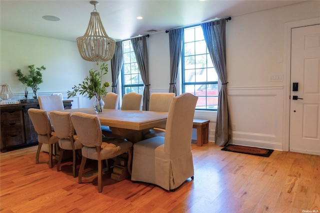 dining room featuring visible vents, a notable chandelier, and light wood finished floors