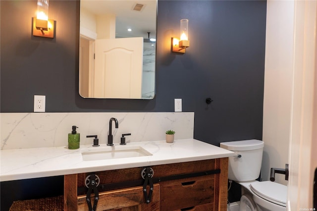 bathroom featuring toilet, tasteful backsplash, visible vents, and vanity