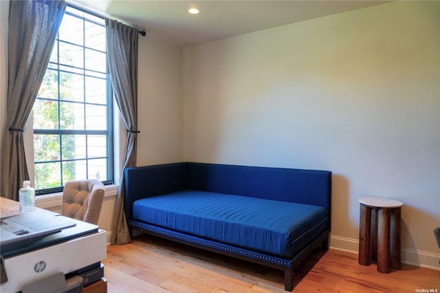 bedroom featuring light wood finished floors, recessed lighting, and baseboards