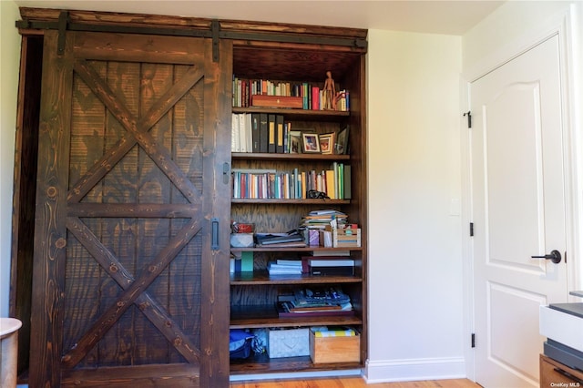 room details featuring baseboards and wood finished floors