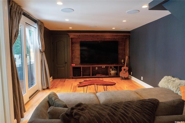 cinema room with recessed lighting, light wood-type flooring, and baseboards