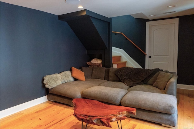 living area featuring light wood finished floors, recessed lighting, visible vents, stairway, and baseboards