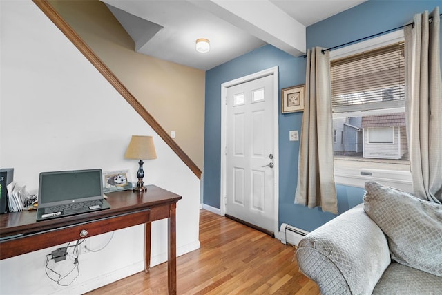 entrance foyer with baseboards, baseboard heating, and light wood-style flooring