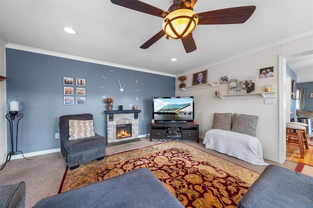 living area with a stone fireplace, crown molding, baseboards, and carpet floors