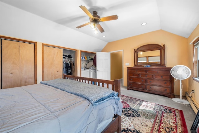 carpeted bedroom with two closets, a ceiling fan, recessed lighting, washing machine and clothes dryer, and vaulted ceiling