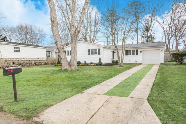 view of front facade with an attached garage, driveway, and a front lawn