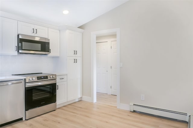 kitchen featuring a baseboard radiator, light countertops, appliances with stainless steel finishes, light wood-style floors, and white cabinetry