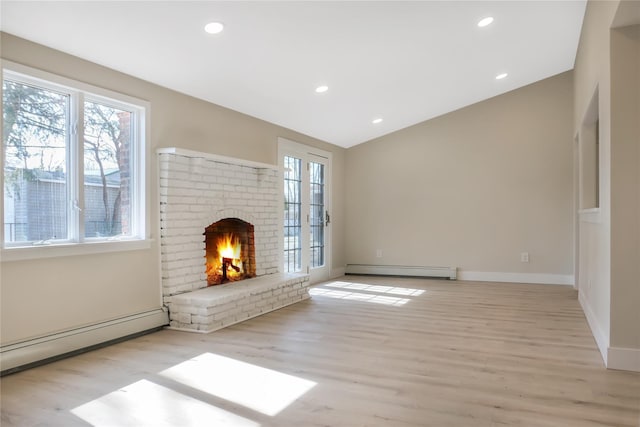 unfurnished living room featuring a baseboard heating unit, a fireplace, wood finished floors, and recessed lighting