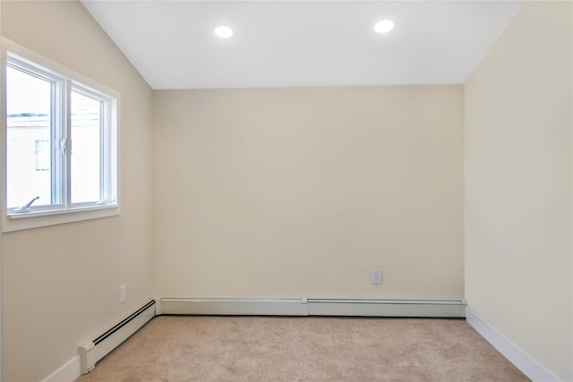 unfurnished room with recessed lighting, a baseboard heating unit, and light colored carpet