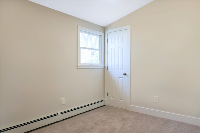 unfurnished room with a baseboard heating unit, light carpet, and vaulted ceiling