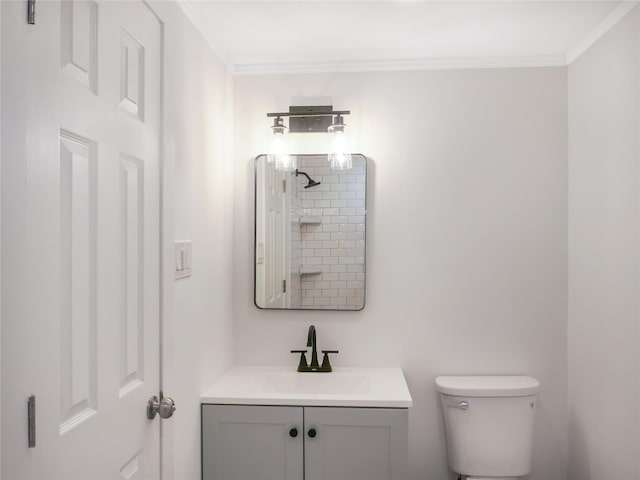 bathroom with a shower, ornamental molding, vanity, and toilet