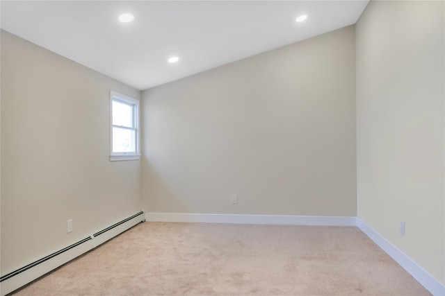 empty room featuring light carpet, baseboards, baseboard heating, and recessed lighting