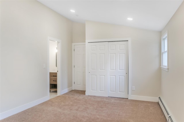 unfurnished bedroom featuring baseboards, light colored carpet, vaulted ceiling, and baseboard heating