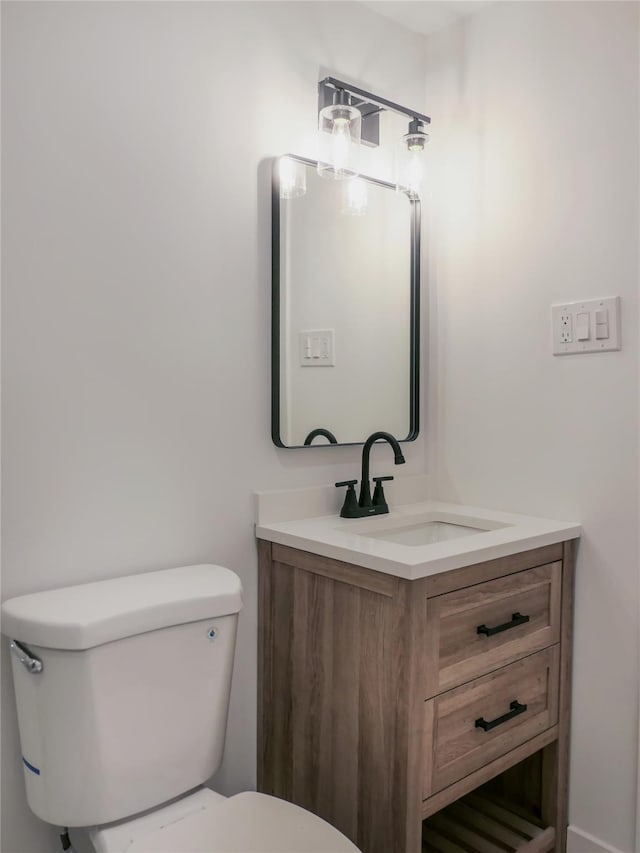 bathroom featuring toilet and vanity