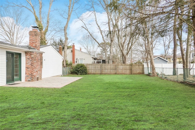 view of yard featuring a patio area and a fenced backyard