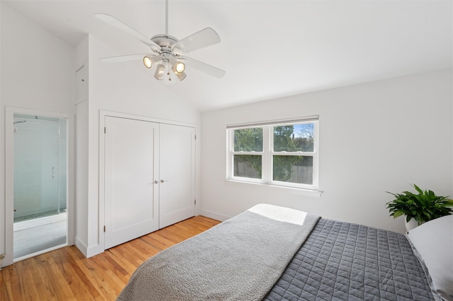 bedroom featuring lofted ceiling, a ceiling fan, a closet, and light wood finished floors