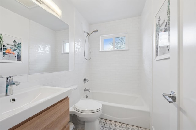 full bath with tile walls, shower / washtub combination, toilet, and vanity