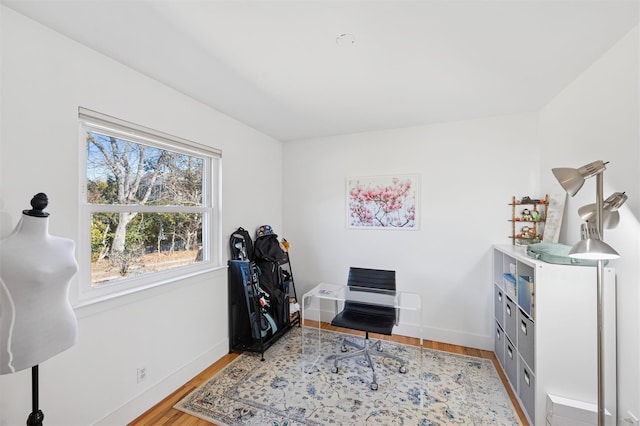 office area featuring baseboards and wood finished floors