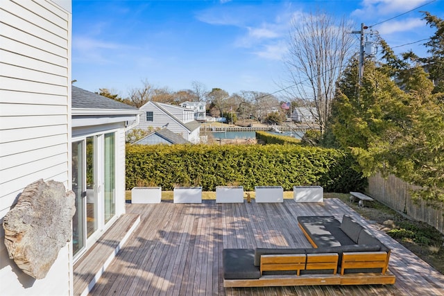 wooden terrace with outdoor dining area and fence