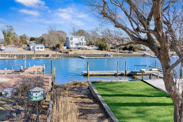 dock area with a water view and a lawn