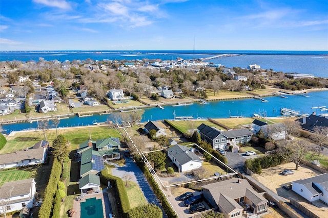 drone / aerial view with a residential view and a water view