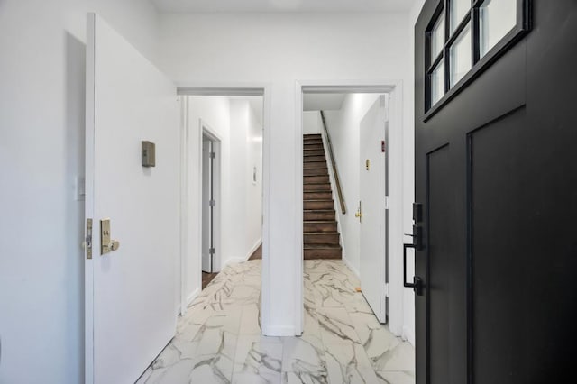 entryway featuring marble finish floor and stairway