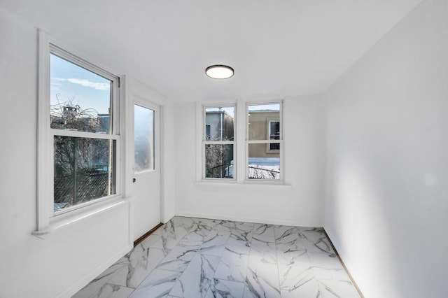 empty room with marble finish floor and baseboards