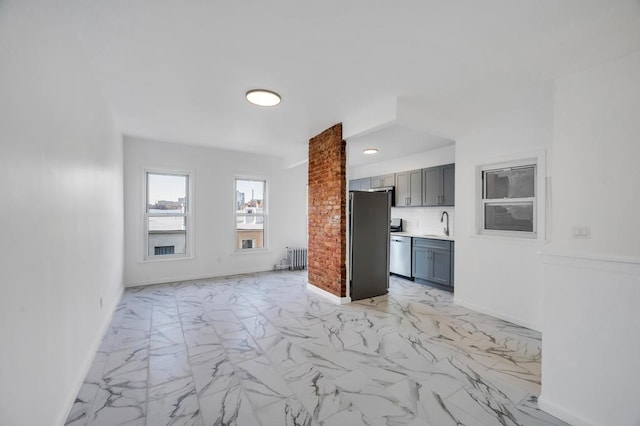 kitchen featuring gray cabinetry, stainless steel appliances, baseboards, marble finish floor, and backsplash