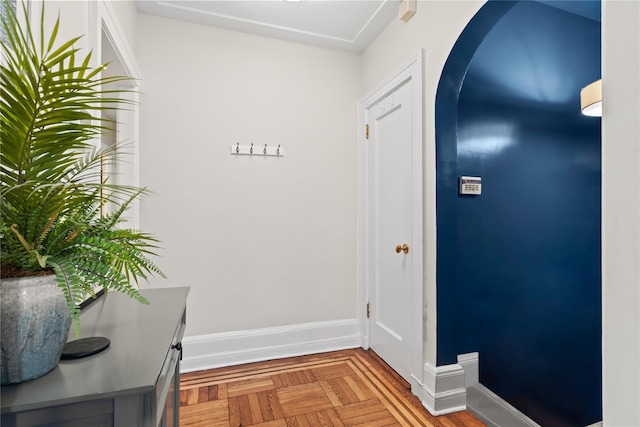 interior space with arched walkways and baseboards