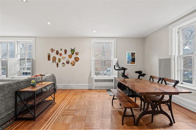 dining space with baseboards, plenty of natural light, and radiator