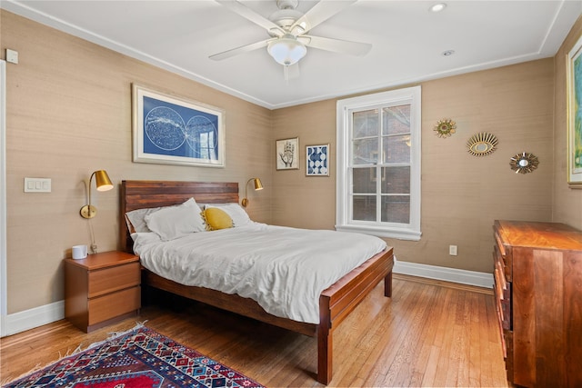 bedroom featuring light wood-style floors, ceiling fan, and baseboards