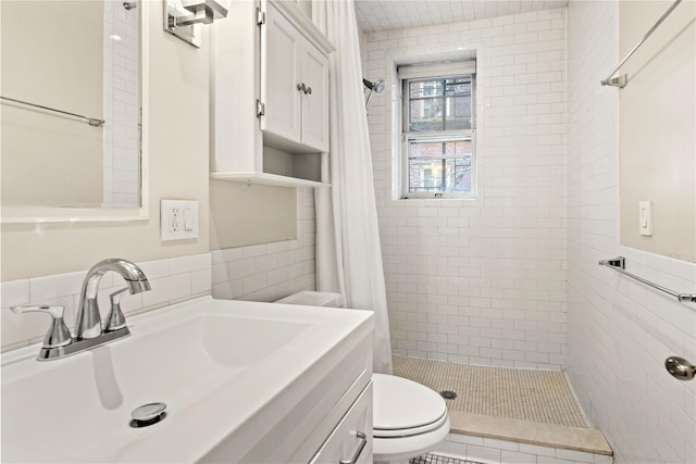 bathroom featuring toilet, a shower stall, tile walls, and vanity