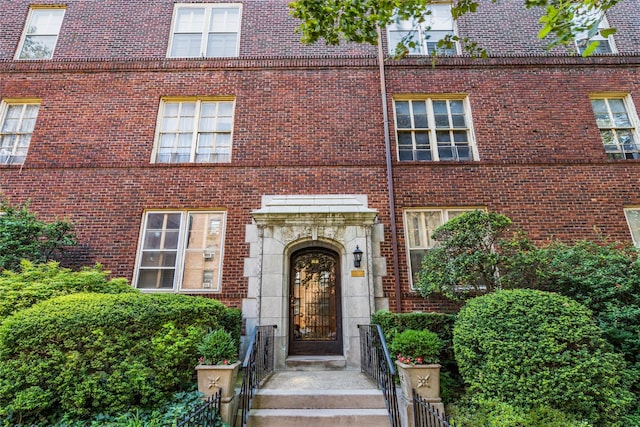 property entrance featuring brick siding