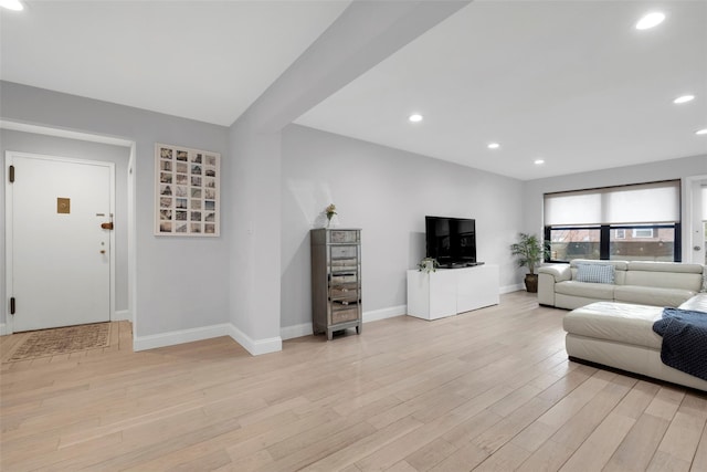 living room with baseboards, light wood-style flooring, and recessed lighting