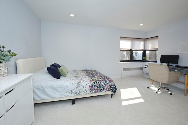 bedroom with light carpet, radiator heating unit, and recessed lighting