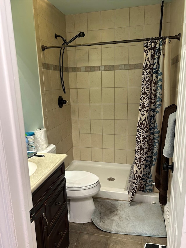 full bathroom with toilet, a stall shower, and vanity