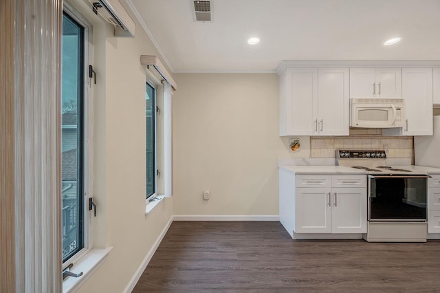 kitchen with dark wood-style flooring, visible vents, backsplash, electric range, and white microwave