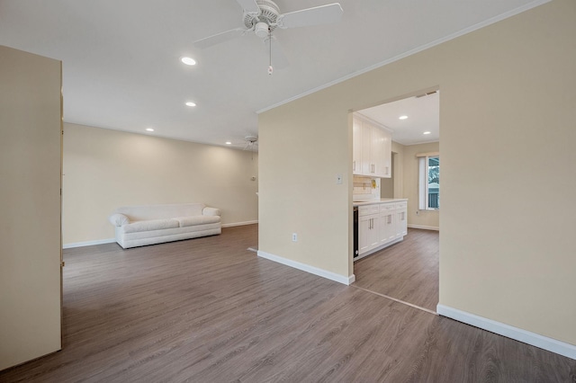 unfurnished living room with recessed lighting, ceiling fan, baseboards, and wood finished floors