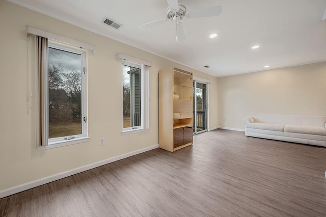 unfurnished living room featuring visible vents, baseboards, a ceiling fan, wood finished floors, and recessed lighting