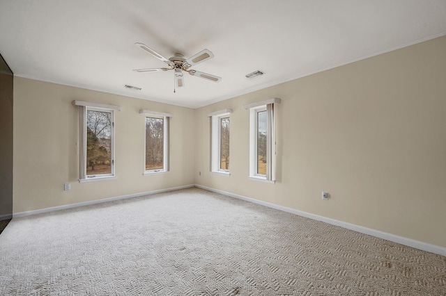 carpeted spare room with visible vents and baseboards