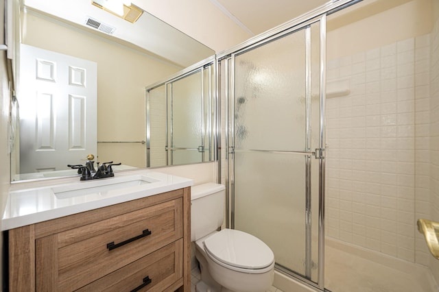 bathroom featuring toilet, a shower stall, visible vents, and vanity