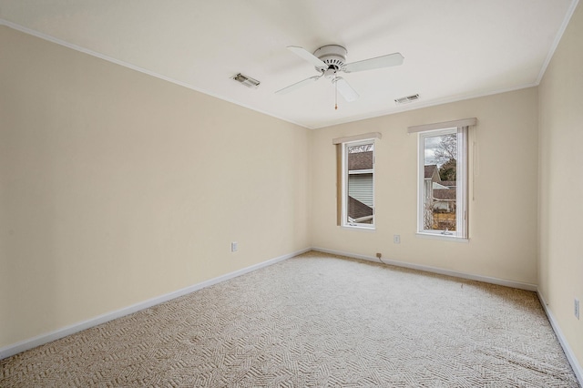 empty room featuring light carpet, baseboards, visible vents, and ceiling fan