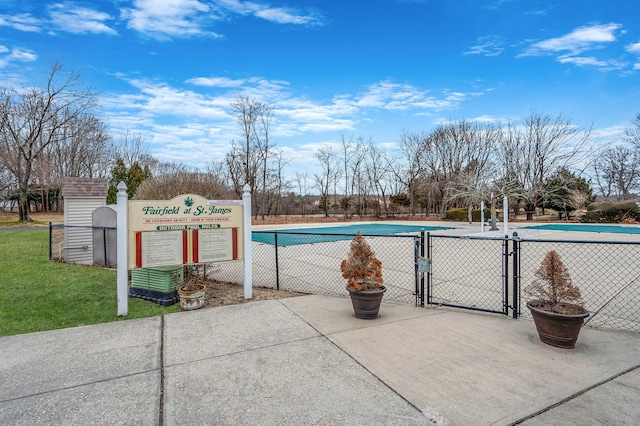 pool featuring a yard, a gate, and fence